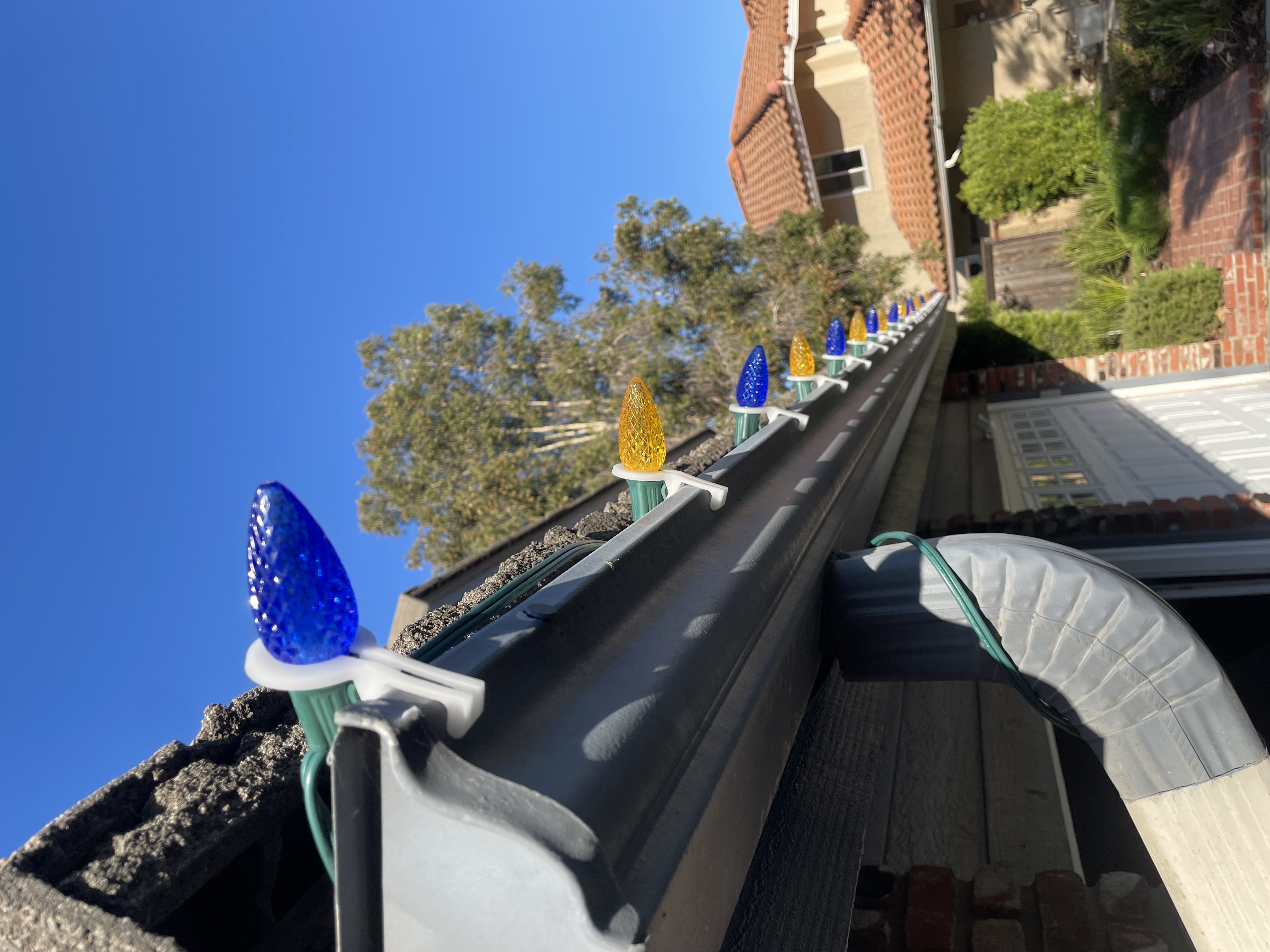 Close-up of custom-cut professional holiday lights installed along a roofline